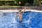 Boy plaiyng in swimming pool