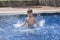 Boy plaiyng in swimming pool