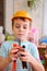 Boy in plastic helmet with toy tools