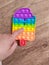 Boy play with colorful poppit fidget toy.