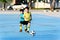 Boy play football on the blue concrete floor.