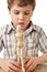 Boy is played by wooden little manikin