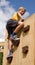 Boy on playground climbing wall