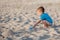 Boy playing on beach. Child play at sea on summer family vacation. Sand and water toys, sun protection for young child. Little boy