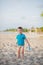 Boy playing on beach. Child play at sea on summer family vacation. Sand and water toys, sun protection for young child. Little boy