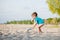 Boy playing on beach. Child play at sea on summer family vacation. Sand and water toys, sun protection for young child. Little boy