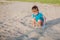 Boy playing on beach. Child play at sea on summer family vacation. Sand and water toys, sun protection for young child. Little boy