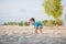 Boy playing on beach. Child play at sea on summer family vacation. Sand and water toys, sun protection for young child. Little boy