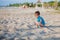 Boy playing on beach. Child play at sea on summer family vacation. Sand and water toys, sun protection for young child. Little boy