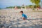 Boy playing on beach. Child play at sea on summer family vacation. Sand and water toys, sun protection for young child. Little boy