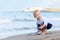 Boy playing on the beach with a ship. Summer vacation and travel