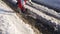 Boy playing with boat an the snow creek, slow motion