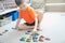 Boy playing with car collection on carpet.Child play home. Transportation, airplane, plane and helicopter toys for children