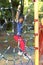 Boy is playing climb net toy in public playground in park on blur playground background in the power of youth condept.jpg