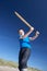 Boy playing cricket on beach