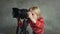 Boy playing with digital camera in studio