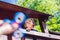 Boy playing with fidget spinner. Child spinning spinner on the playground. Blurred background