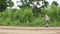 Boy playing football on the sandy road Outdoors