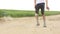 Boy playing football on the sandy road Outdoors