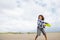 Boy playing frisbee on beach