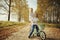 Boy playing with a girl in autumn country road