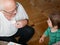 A boy is playing with grandfather. Grandfather and grandson are having fun. played a handmade board game with grandfather