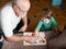 A boy is playing with grandfather. Grandfather and grandson are having fun. played a handmade board game with grandfather