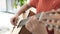 Boy playing guitar while sitting on sofa at home. The concept of learning to play a musical instrument.