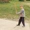 Boy playing hammering starlings