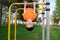 Boy playing with head down outdoors on horizontal bar gym. Kid on playground, children activity. Active healthy