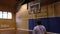 Boy playing indoor basketball alone (3 of 3)