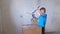 Boy playing with mounting foam while parents don\'t see him. Renovation at home.