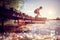 Boy playing on a pier by lake on summer vacation