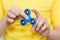 A boy is playing a popular toy fidget spinner in his hands.