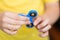 A boy is playing a popular toy fidget spinner in his hands. Stress relief. Anti stress and relaxation fidgets, spinner for tired.