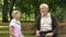 Boy playing rock paper scissors game with granddad, old man lose and give banana