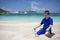 Boy playing with sand on the beach