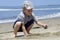 Boy playing in the sand near the Pacific Ocean