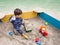 Boy playing in sandbox