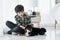 A boy is playing with a Shiba Inu in a bedroom in an apartment. boy and black shiba inu dog