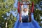 Boy Playing on a slide at the park