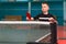 Boy playing table tennis, photo through the net