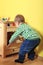 Boy playing with wooden stove in kindergarten