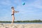 A boy plays beach volleyball. Side view. Sport lifestyle