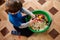 Boy plays  game, grain and groats with small toys are poured into a basin, a child plays, development of autism and a game for