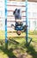 A boy plays outdoors on the playground.