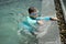 Boy plays water alone beside pool in summer concept