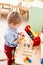 Boy plays with wooden toys