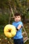 Boy pluck ripe apples from the tree with special device