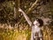 Boy Points at the Solar Eclipse Wearing Paper Glasses